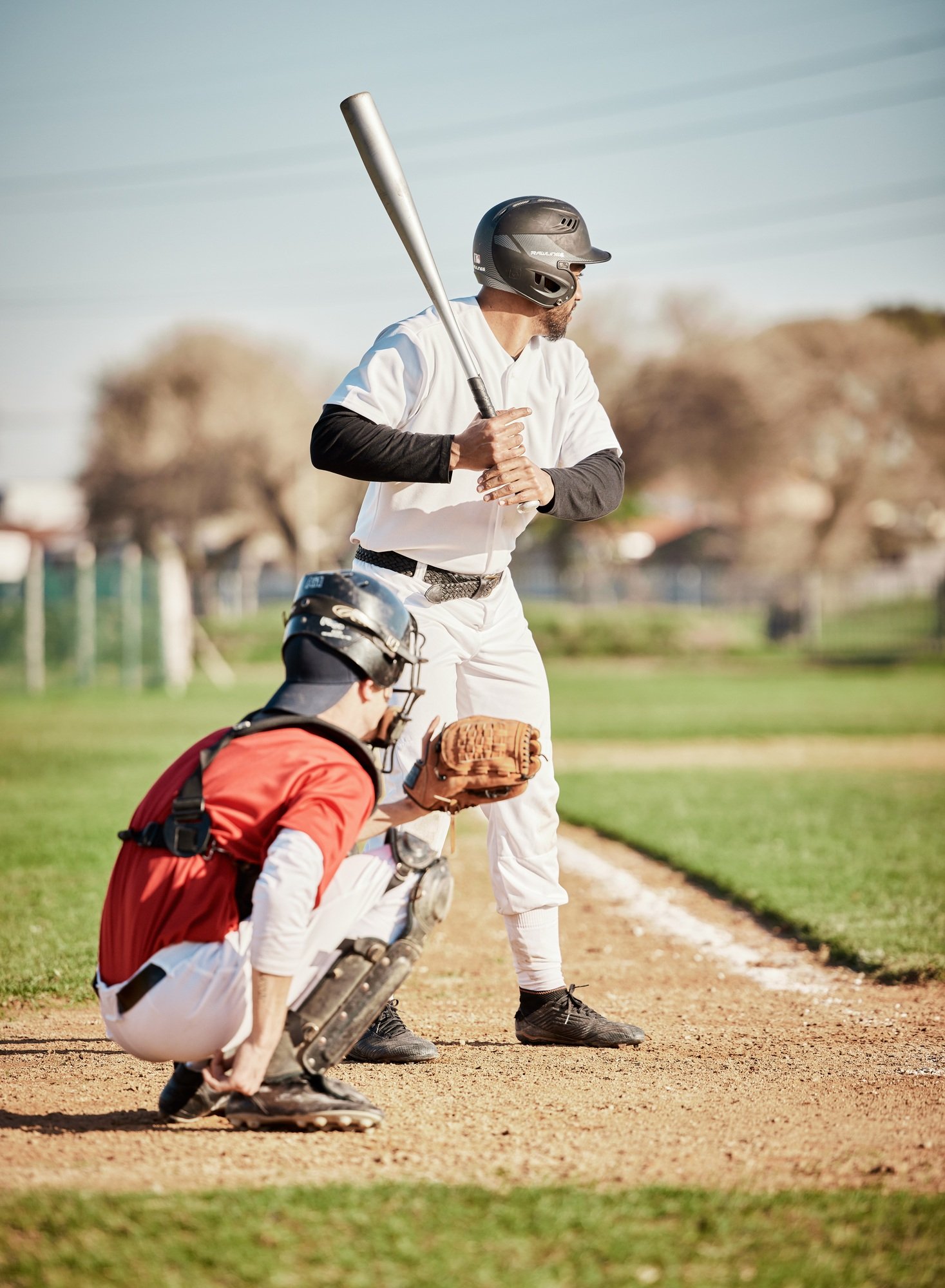 Baseball, bat and focus with a sports man outdoor, playing a competitive game during summer. Fitnes